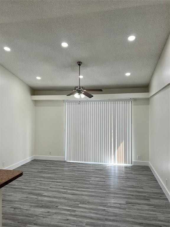 931 Lyons Road, Unit 4204 Coconut Creek, FL 33063 - Photo 16 of 17 an empty room with wooden floor chandelier and windows