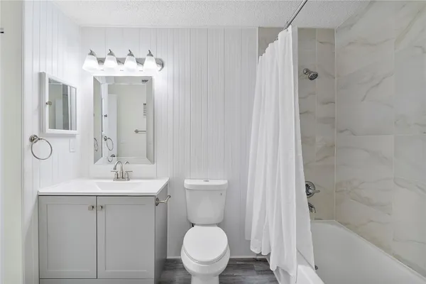 a bathroom with a sink toilet and shower