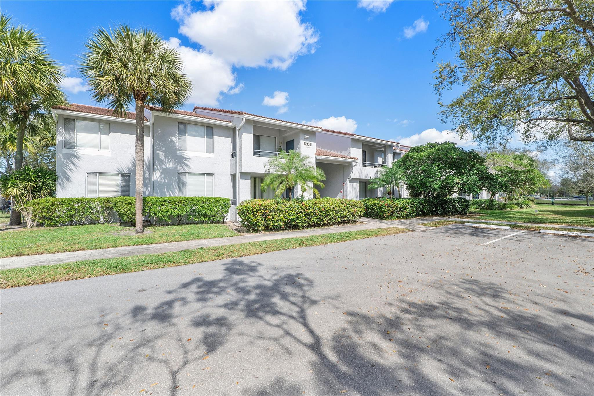 931 Lyons Road, Unit 4204 Coconut Creek, FL 33063 - Photo 10 of 17 a view of a house with a yard and potted plants