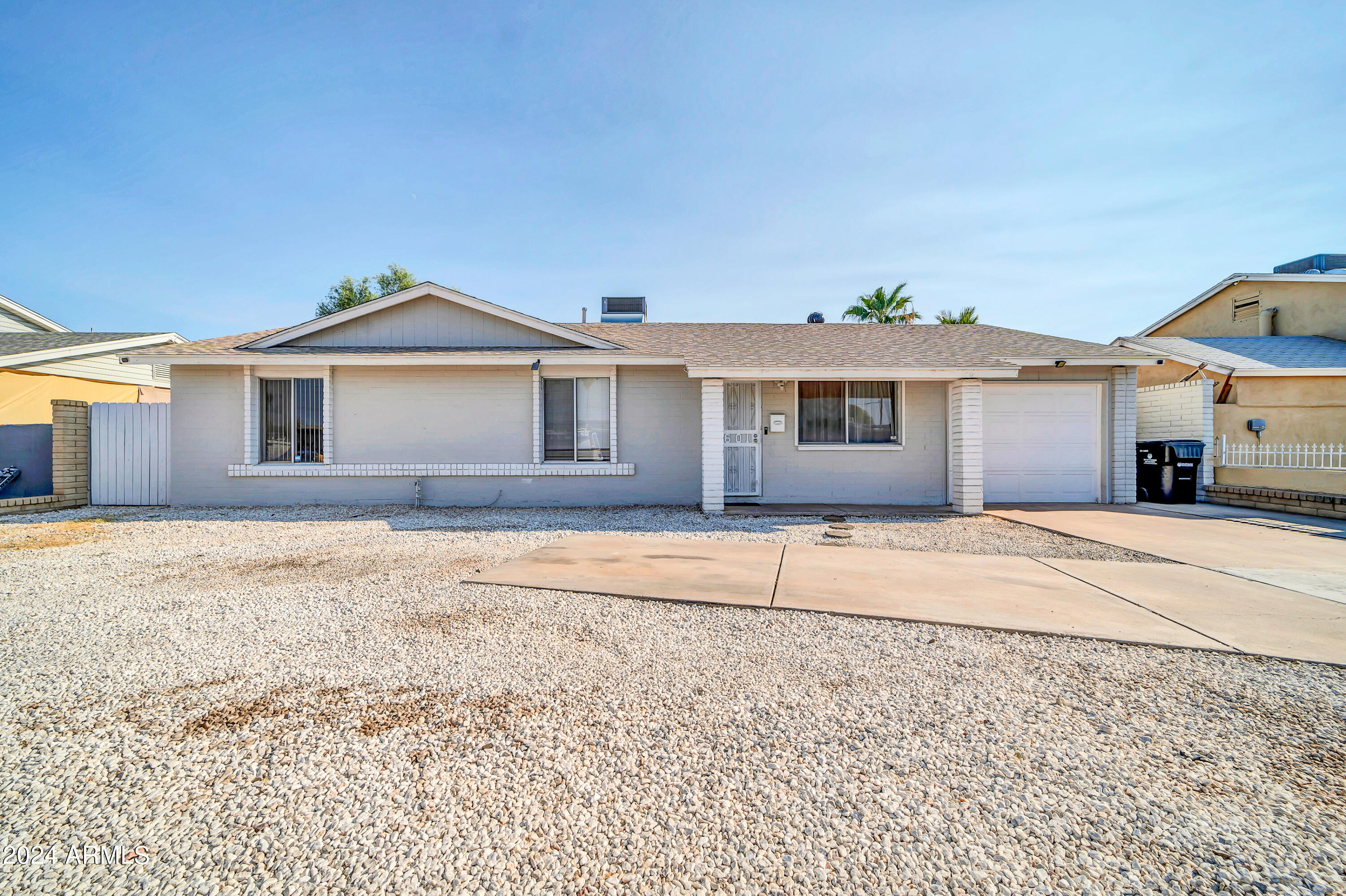 7601 West Osborn Road Phoenix, AZ 85033 - Photo 1 of 37 a front view of a house with a yard
