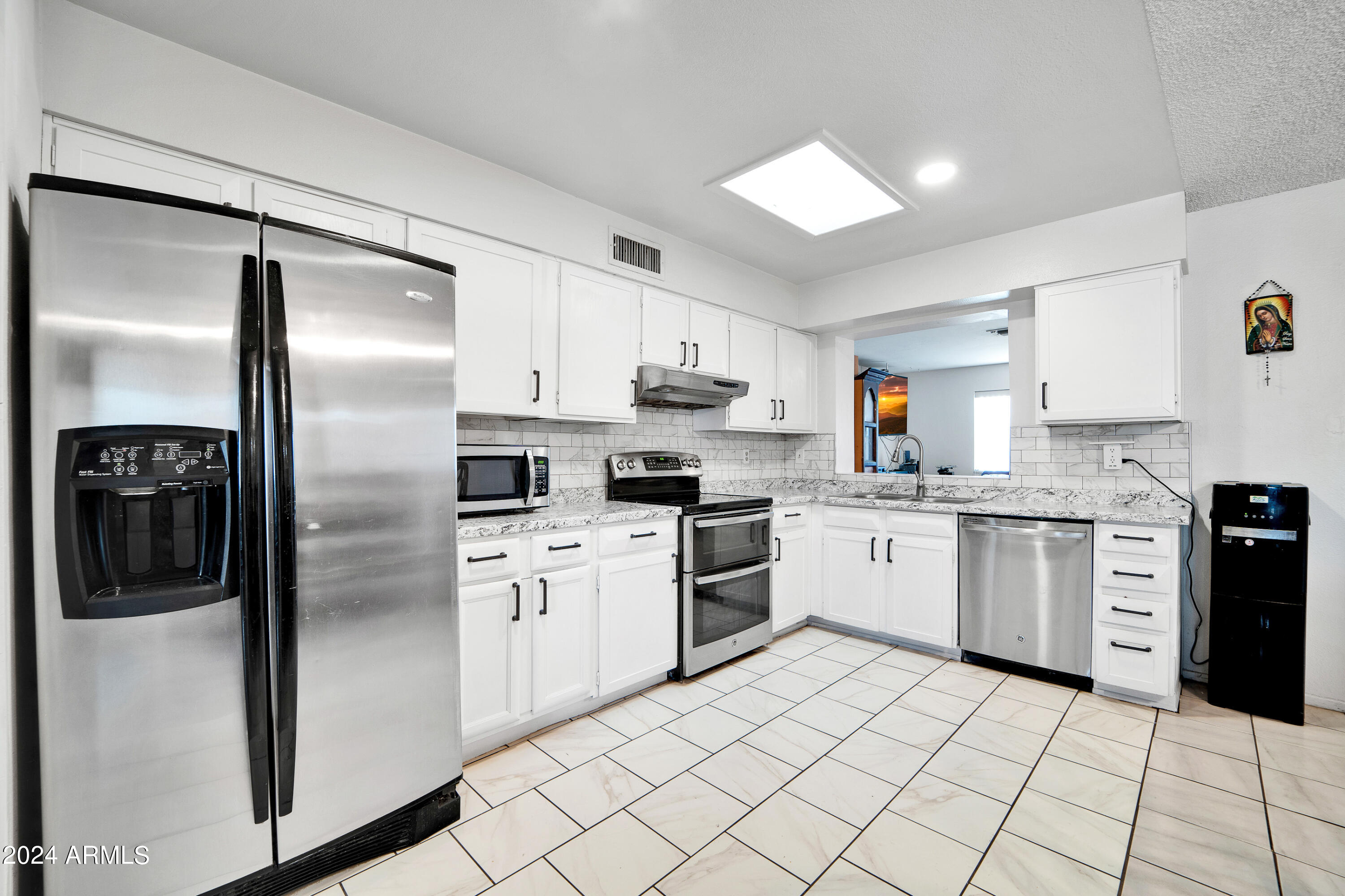 7601 West Osborn Road Phoenix, AZ 85033 - Photo 14 of 37 a kitchen with granite countertop stainless steel appliances cabinets and a sink