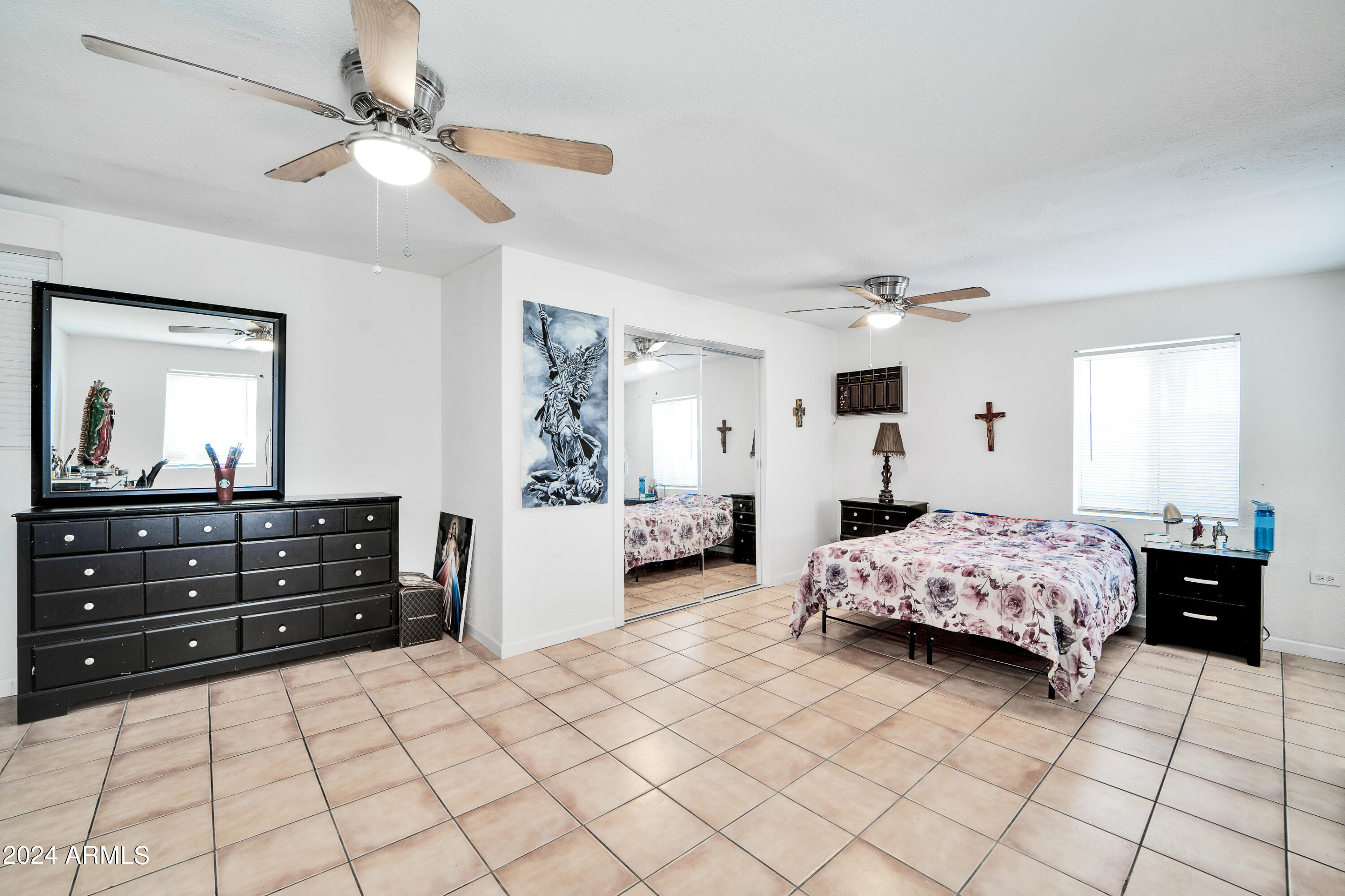 7601 West Osborn Road Phoenix, AZ 85033 - Photo 23 of 37 a bedroom with a bed and a dresser