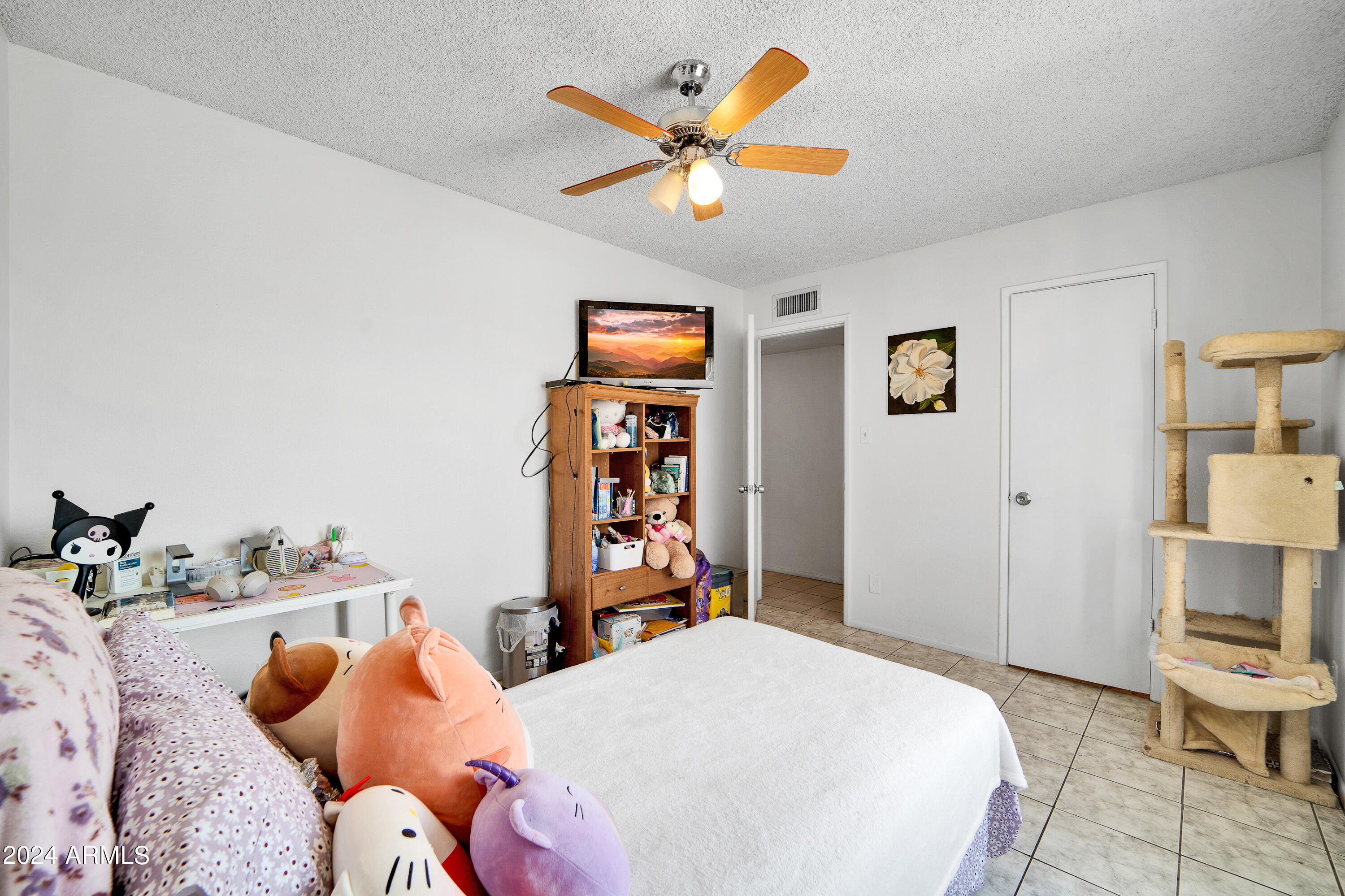 7601 West Osborn Road Phoenix, AZ 85033 - Photo 26 of 37 a bedroom with bed and a chandelier