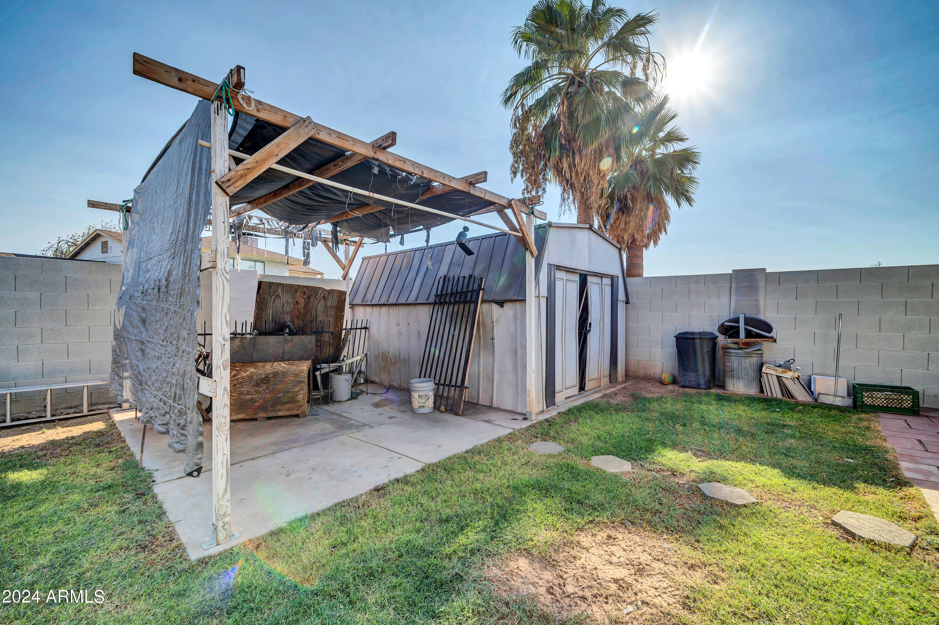 7601 West Osborn Road Phoenix, AZ 85033 - Photo 33 of 37 a view of a backyard with a small cabin and a chair