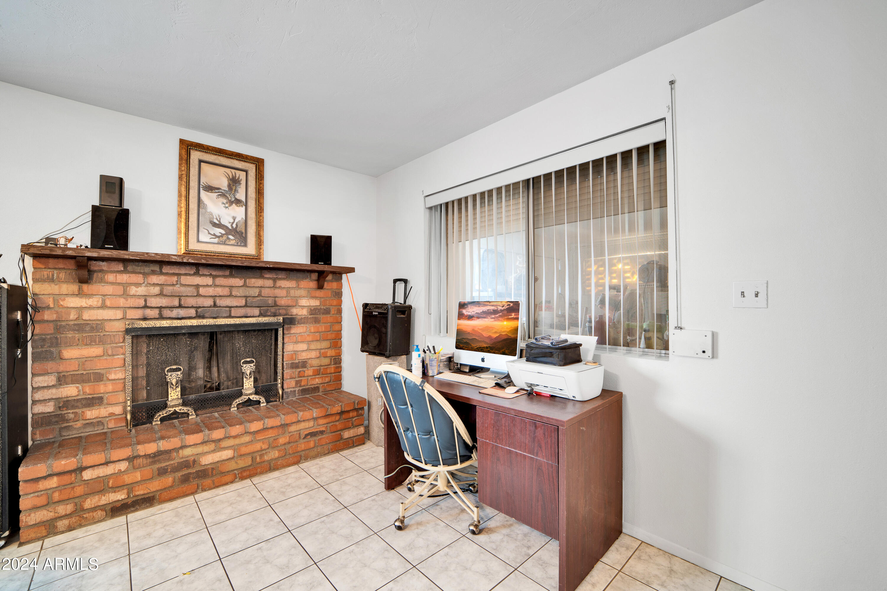 7601 West Osborn Road Phoenix, AZ 85033 - Photo 7 of 37 a living room with furniture a fireplace and a window
