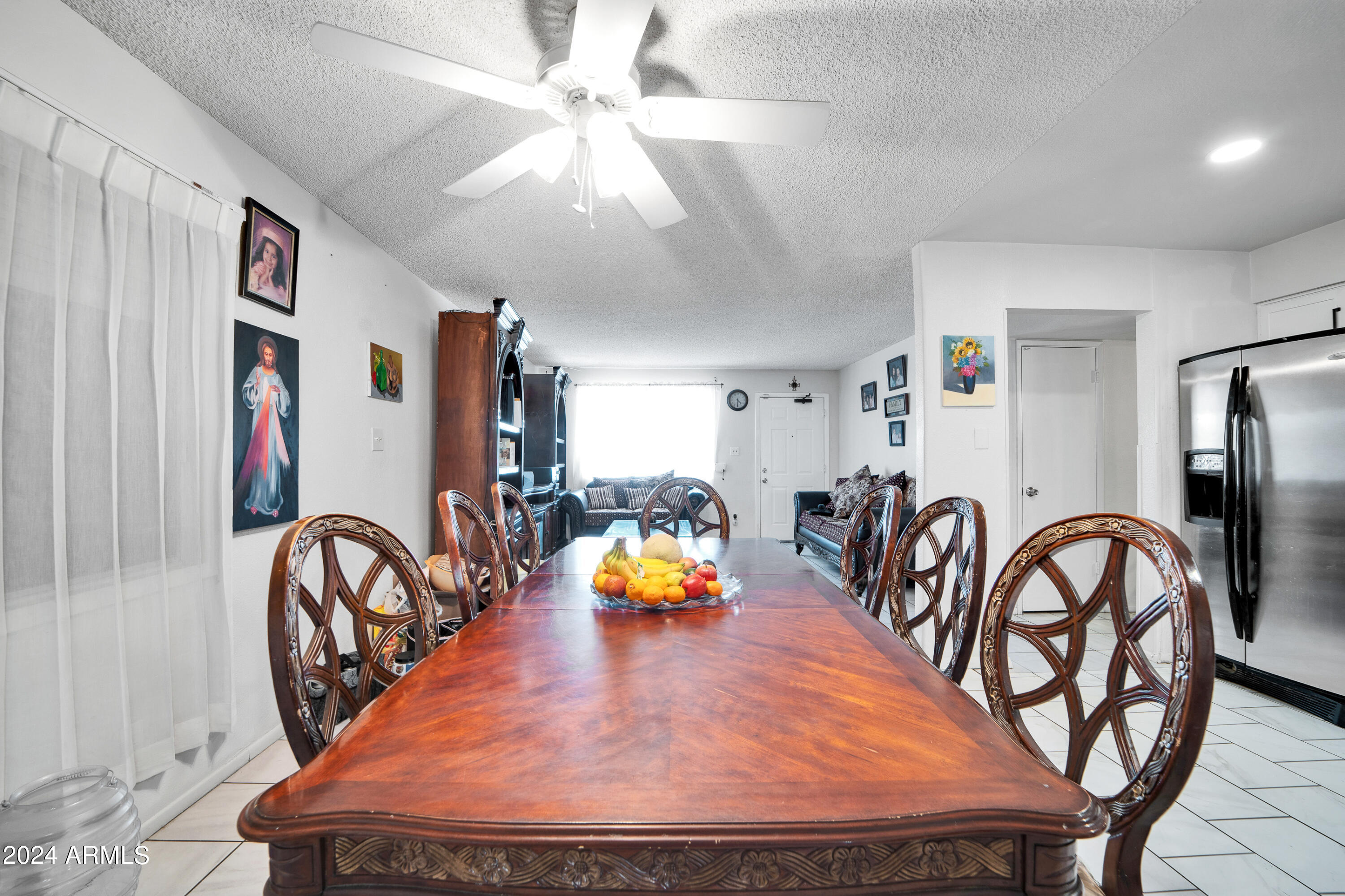 7601 West Osborn Road Phoenix, AZ 85033 - Photo 10 of 37 a bedroom with furniture and a chandelier