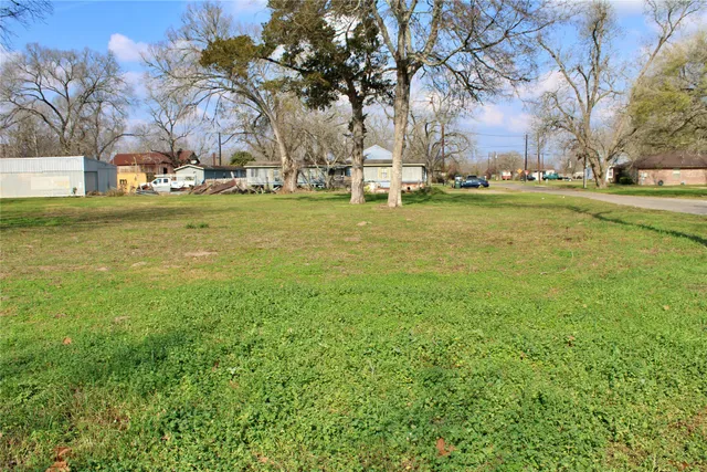 a backyard of apartments with large trees