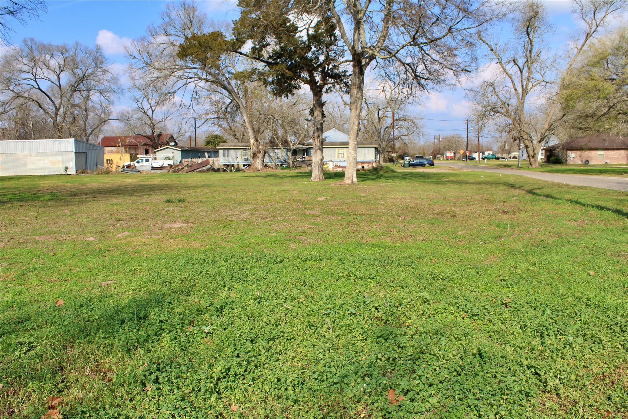 638 Prairie Street Columbus, TX 78934 - Photo 4 of 6 a backyard of apartments with large trees
