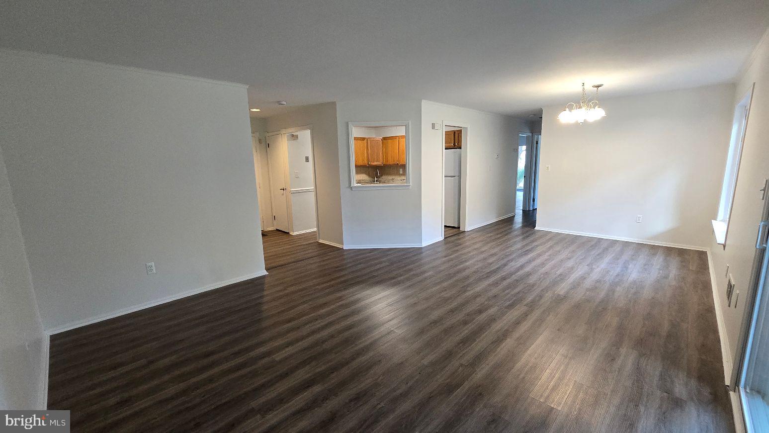 325 Silvia Street Ewing, NJ 08628 - Photo 12 of 21 a view of an empty room with wooden floor and a window