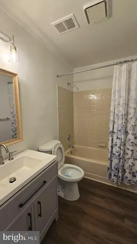 a bathroom with a sink a toilet a mirror and shower