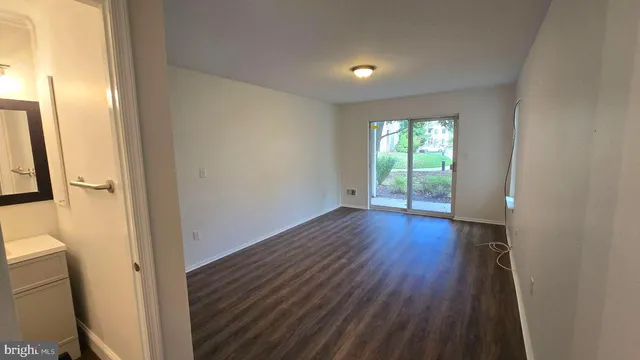 a view of hallway with wooden floor and fence