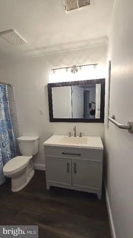 a bathroom with a toilet sink and mirror
