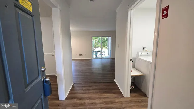 a view of hallway with wooden floor