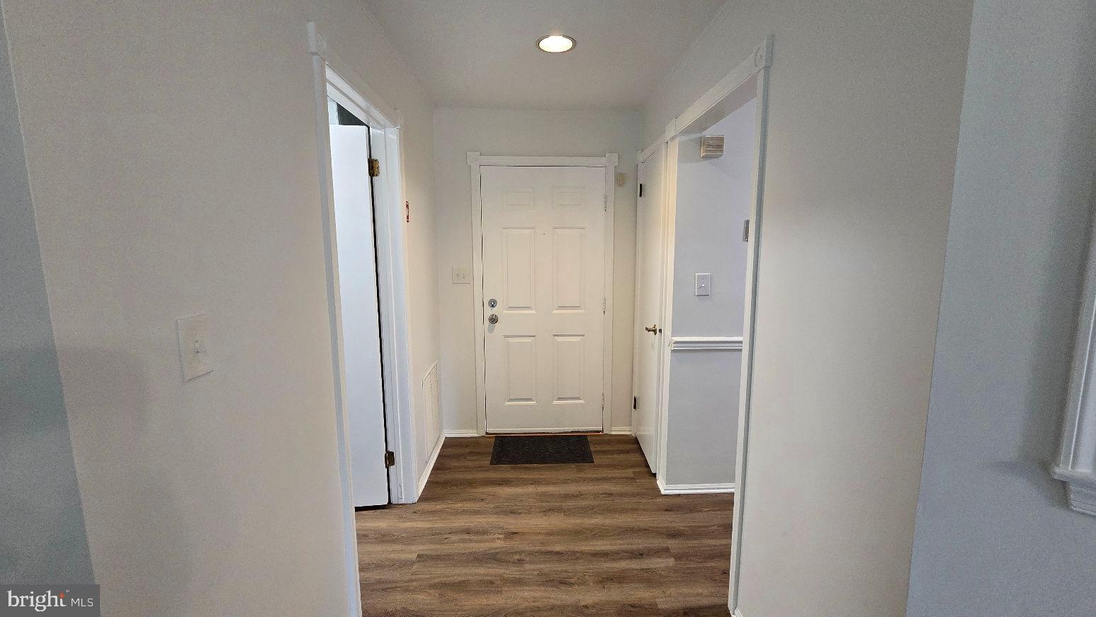 325 Silvia Street Ewing, NJ 08628 - Photo 4 of 21 a view of a hallway with wooden floor and closet