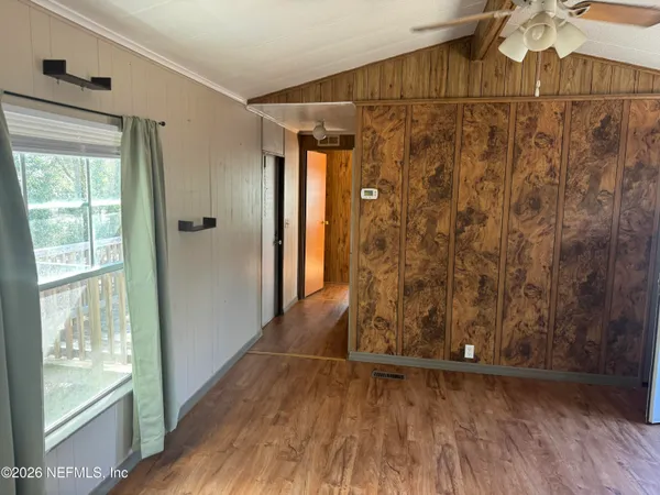 a view of walk in closet with wooden floor