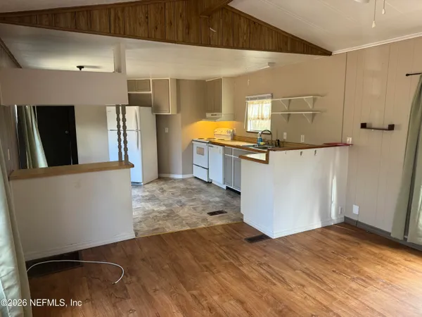 a kitchen with stainless steel appliances a refrigerator and a stove