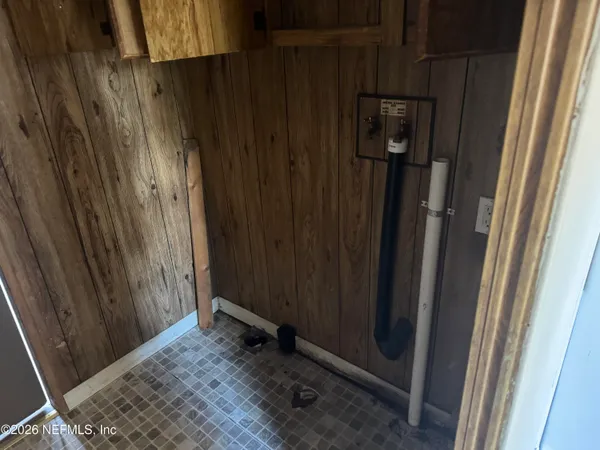 a view of a closet and wooden door