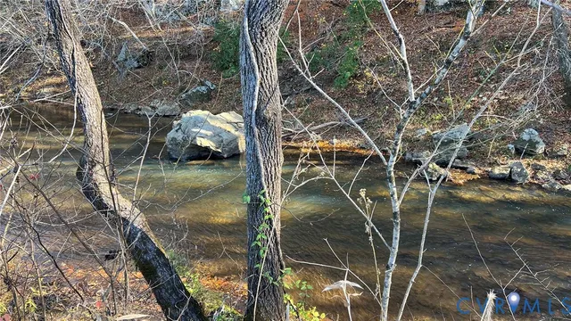 a backyard of a house with lots of green space and two chairs