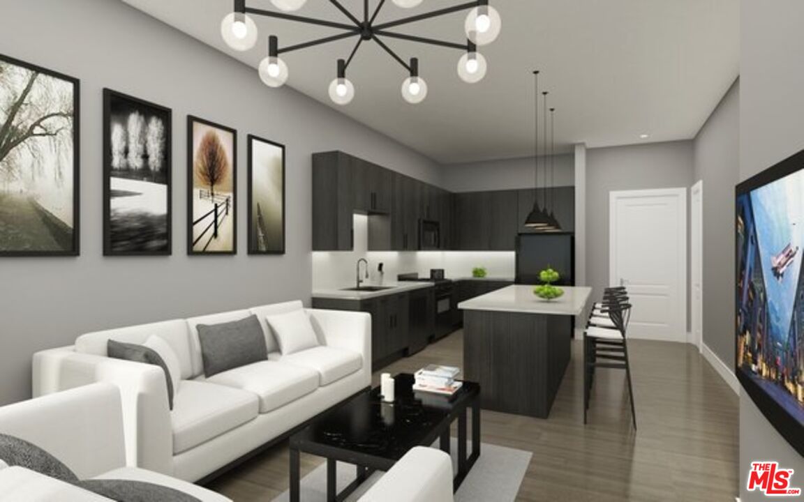 1120 West 6th Street, Unit 2257 Los Angeles, CA 90017 - Photo 11 of 51 a living room with furniture a flat screen tv and kitchen view