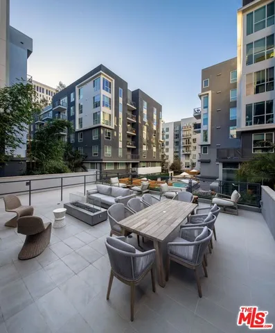 a view of a patio with couches and a fire pit
