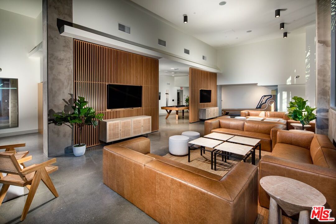 1120 West 6th Street, Unit 2257 Los Angeles, CA 90017 - Photo 24 of 51 a living room with furniture and a flat screen tv