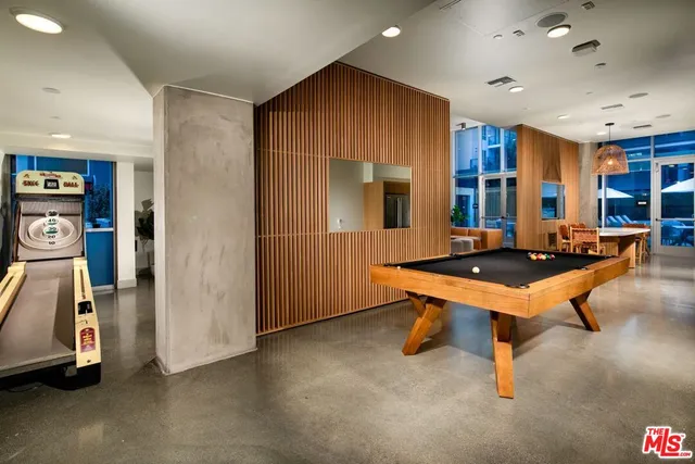 a room with pool table and windows