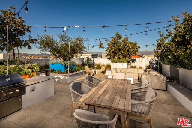a terrace with outdoor seating and city view