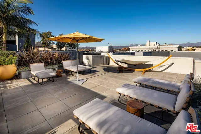 an outdoor space with patio area and white umbrellas