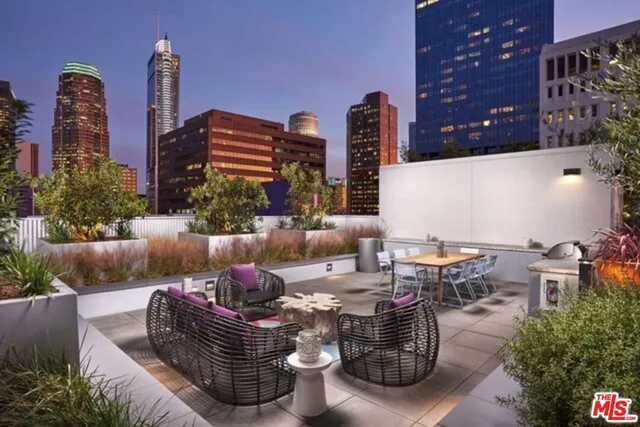 a view of a patio with couches table and chairs and potted plants