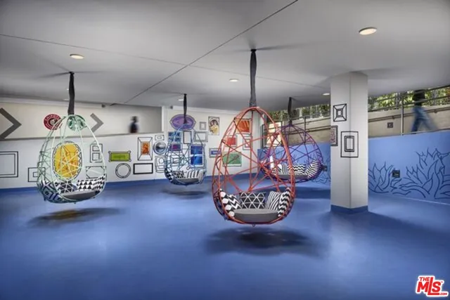 a view of a patio with couches table and chairs under an umbrella