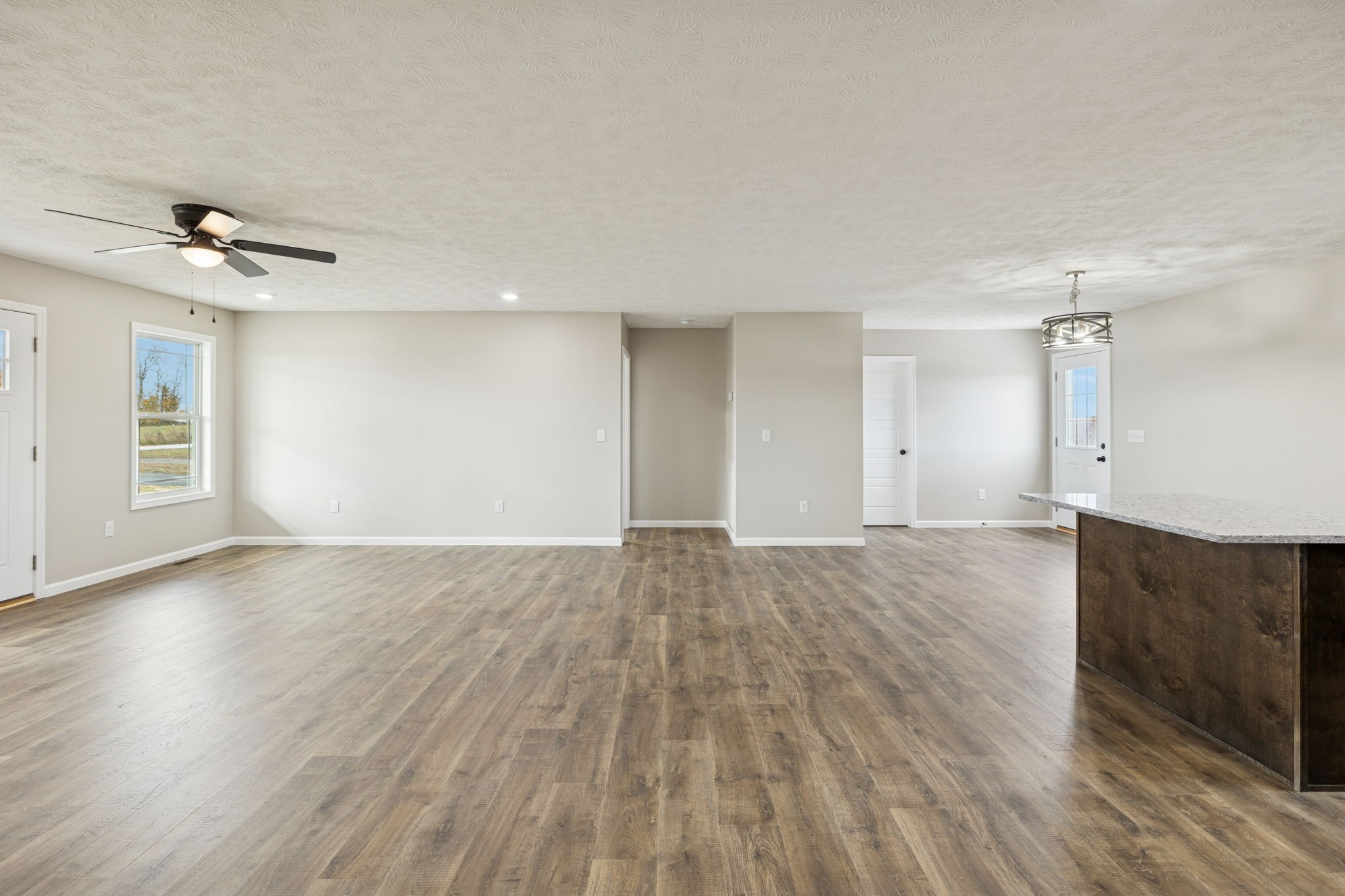 2623 Oak Knob Road Lafayette, TN 37083 - Photo 17 of 36 a view of an empty room with wooden floor and a ceiling fan