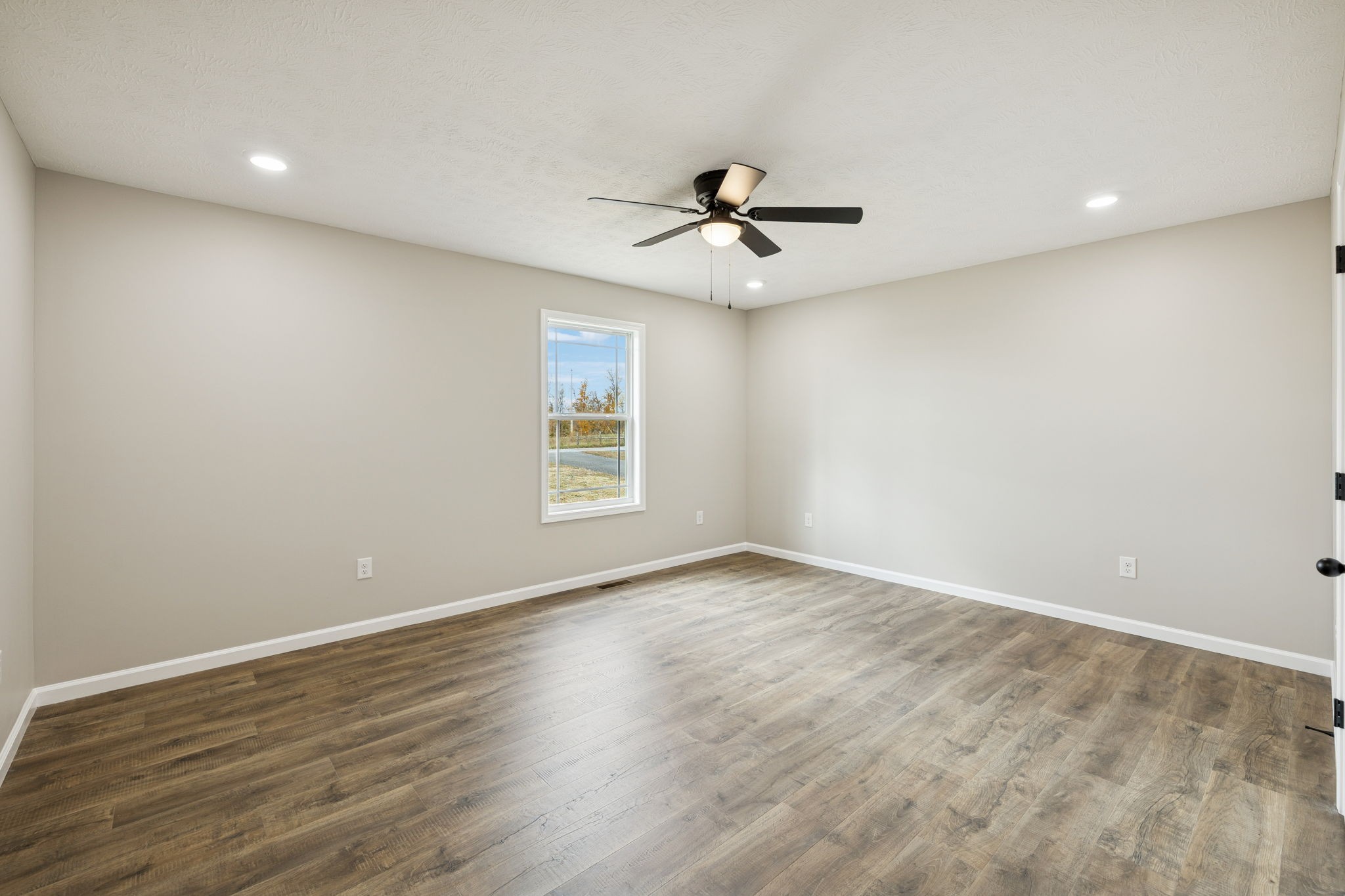2623 Oak Knob Road Lafayette, TN 37083 - Photo 18 of 36 a view of empty room with wooden floor and fan