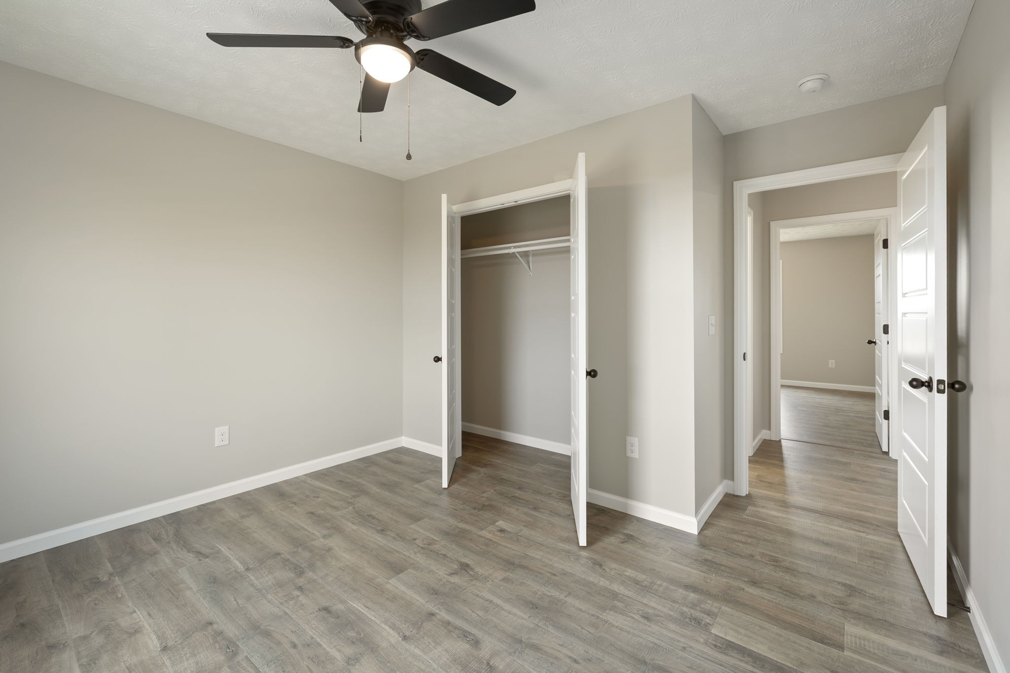 2623 Oak Knob Road Lafayette, TN 37083 - Photo 26 of 36 an empty room with wooden floor a ceiling fan and a window