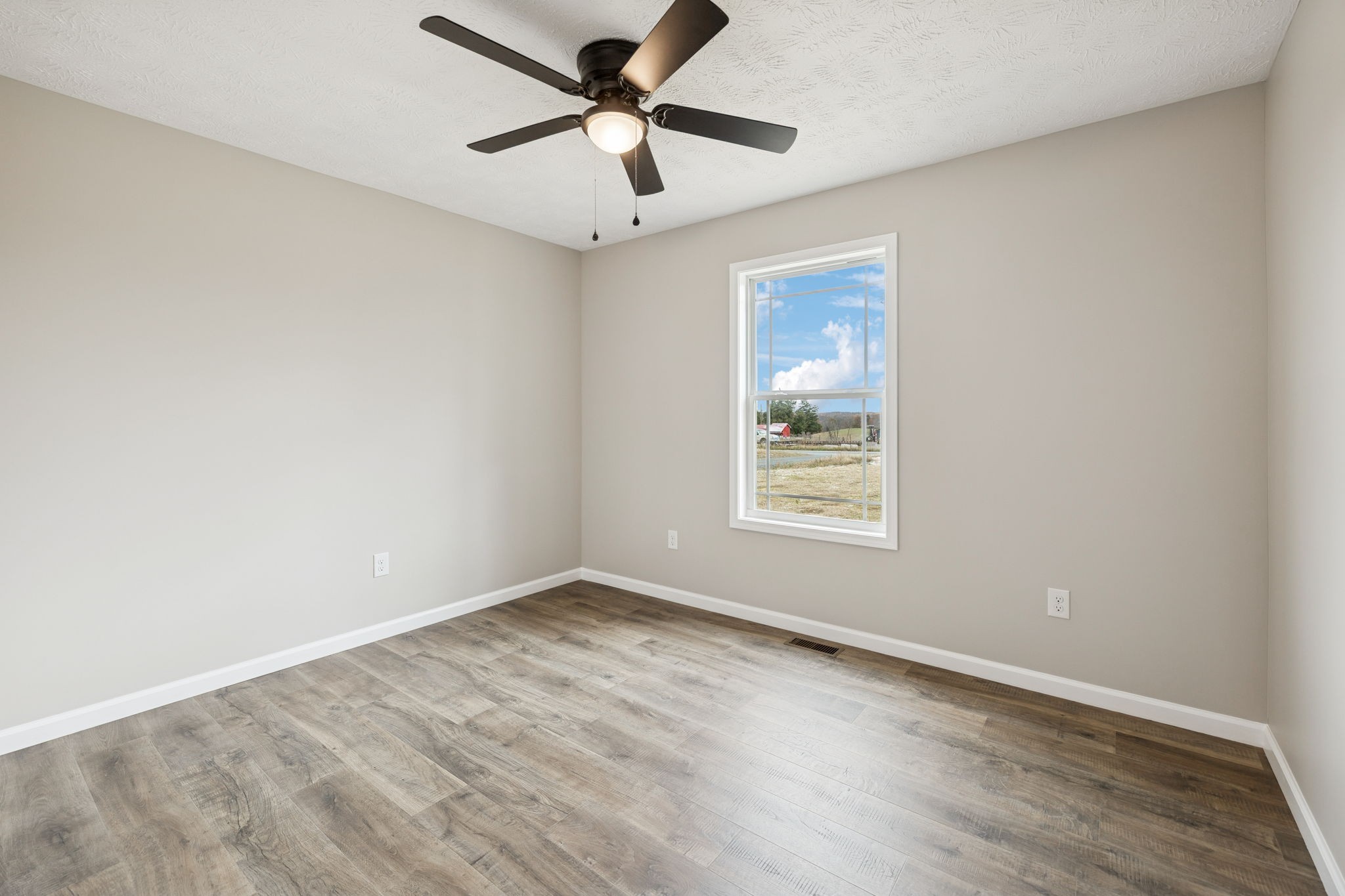 2623 Oak Knob Road Lafayette, TN 37083 - Photo 28 of 36 an empty room with wooden floor and windows