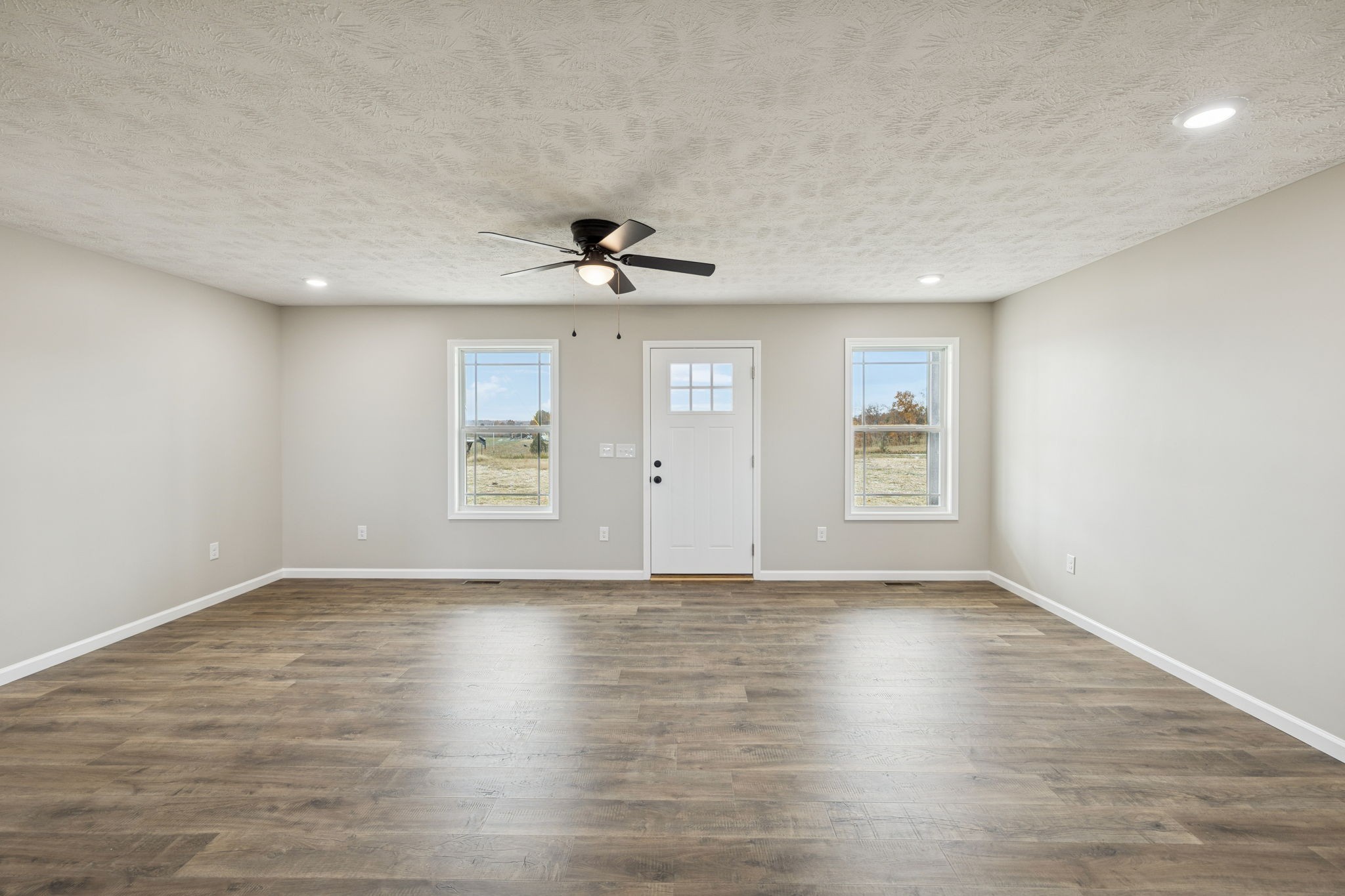 2623 Oak Knob Road Lafayette, TN 37083 - Photo 6 of 36 a view of an empty room with a window and wooden floor