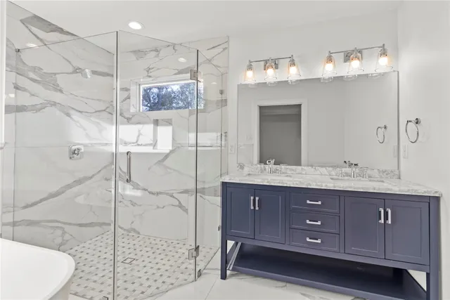 a bathroom with a granite countertop sink mirror and shower