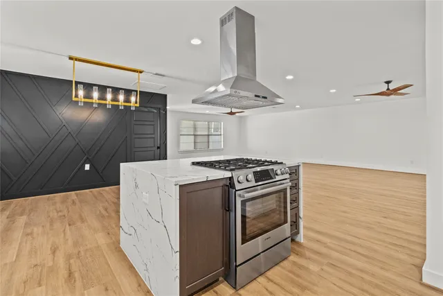 a kitchen with stove and cabinets