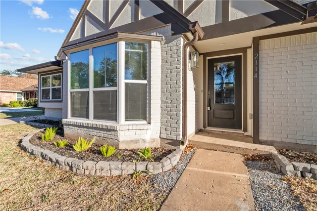 a view of a house with a tub and a small yard