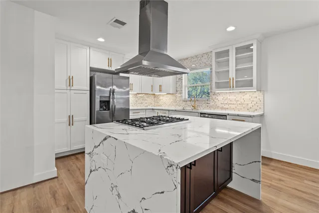 a kitchen with a stove and a sink