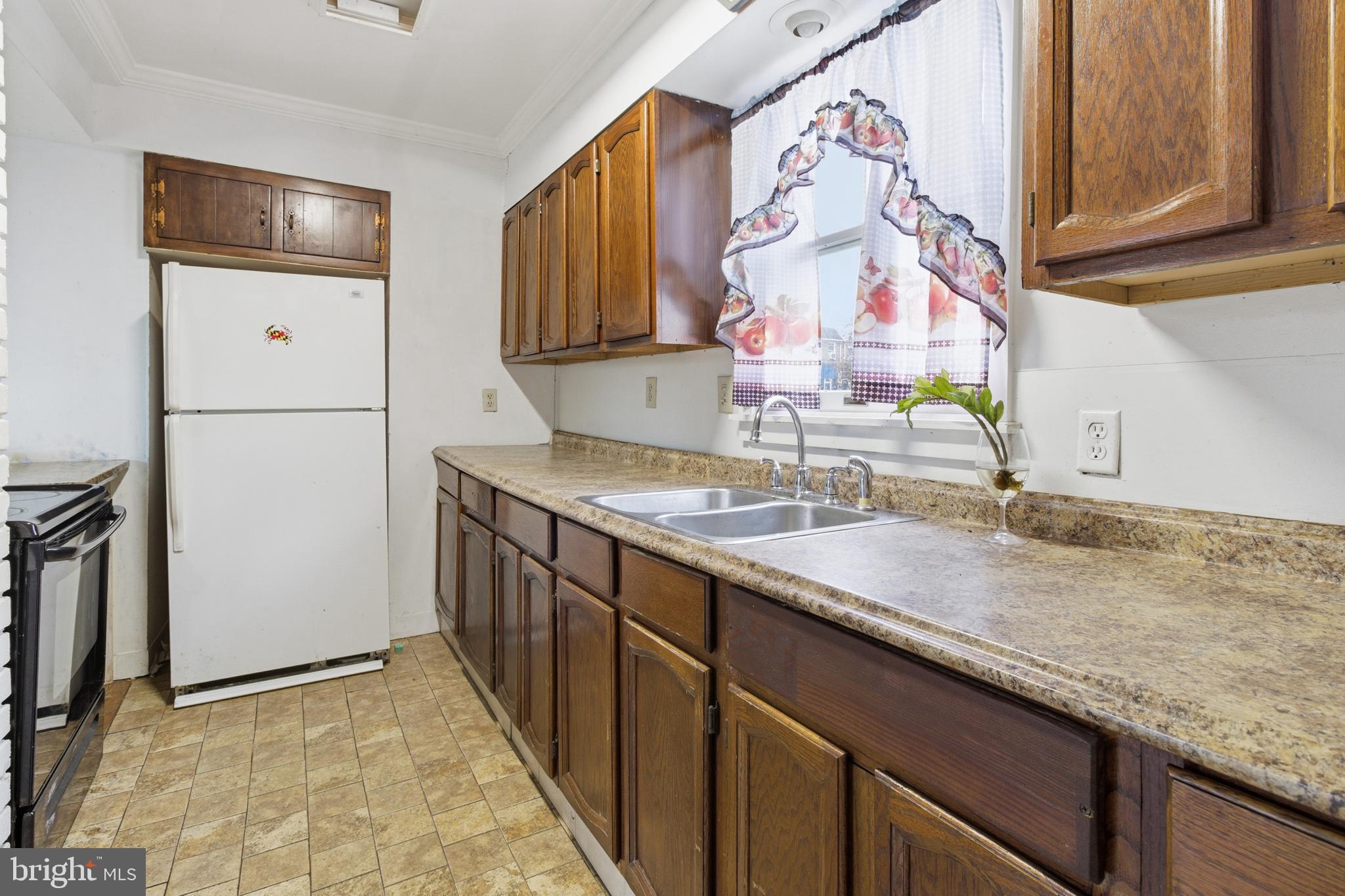 6408 Eastbourne Avenue Baltimore, MD 21224 - Photo 11 of 34 a bathroom with a sink and a mirror