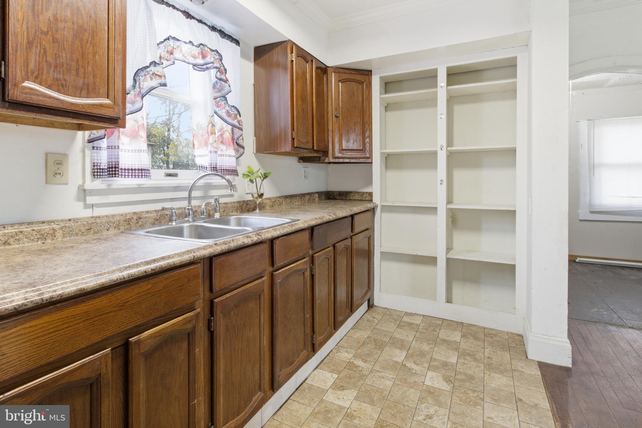 6408 Eastbourne Avenue Baltimore, MD 21224 - Photo 13 of 34 a bathroom with a granite countertop sink and a mirror