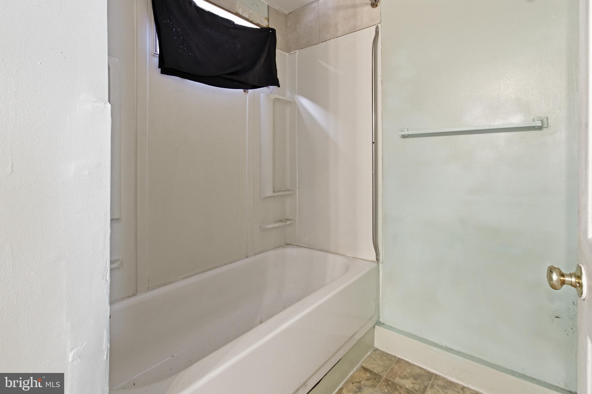 6408 Eastbourne Avenue Baltimore, MD 21224 - Photo 23 of 34 a bathroom with a bathtub and a toilet