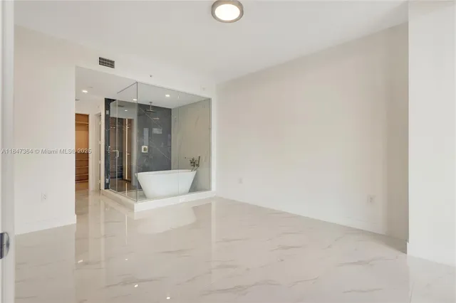 an outdoor sitting area with furniture and umbrella