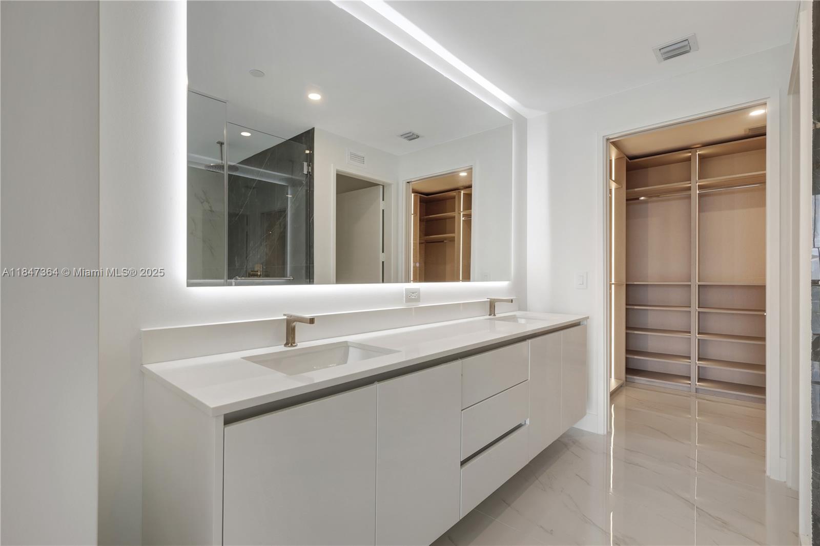 700 Northeast 24th Street, Unit 1603 Miami, FL 33137 - Photo 36 of 67 a bathroom with a sink and a mirror