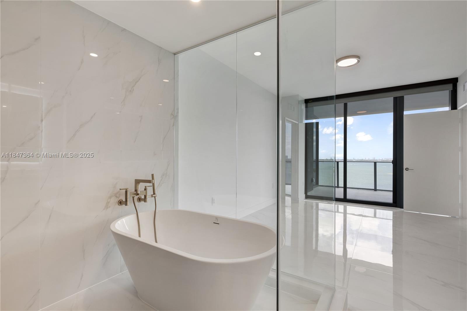 700 Northeast 24th Street, Unit 1603 Miami, FL 33137 - Photo 37 of 67 a bathroom with a bathtub and shower