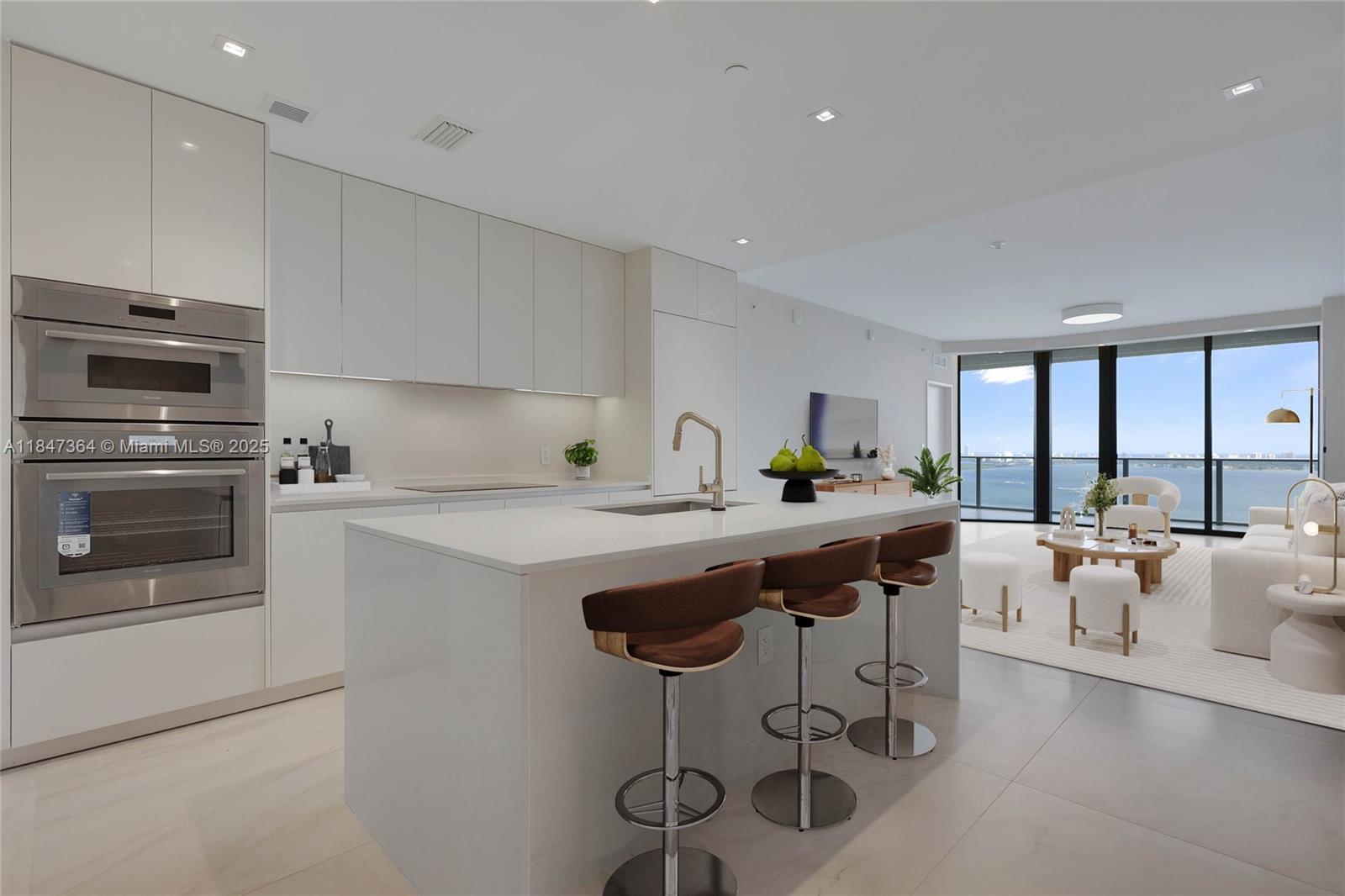 700 Northeast 24th Street, Unit 1603 Miami, FL 33137 - Photo 6 of 67 a kitchen with stainless steel appliances granite countertop a sink and cabinets