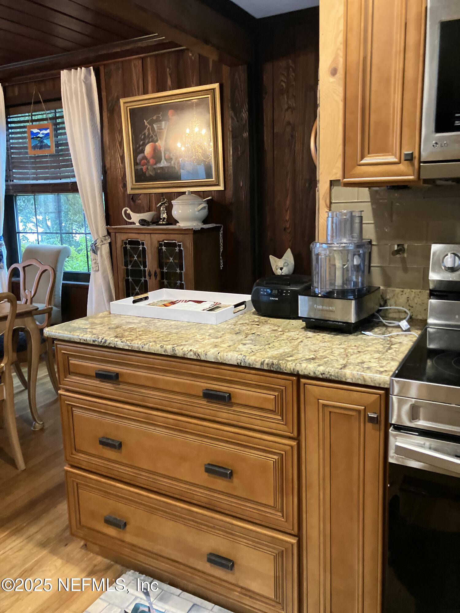 1375 Cedar Bay Road Jacksonville, FL 32218 - Photo 23 of 91 a kitchen with kitchen island granite countertop a stove top oven a sink and dishwasher