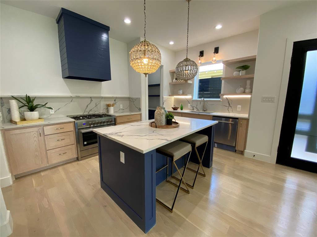 807 South Glasgow Drive Dallas, TX 75223 - Photo 3 of 25 a kitchen with a sink a counter space and stainless steel appliances