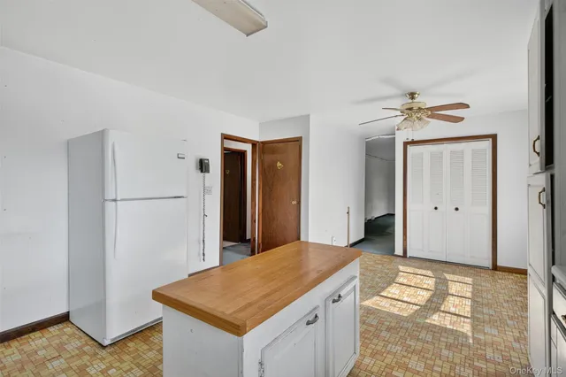 a kitchen with white cabinets and white appliances
