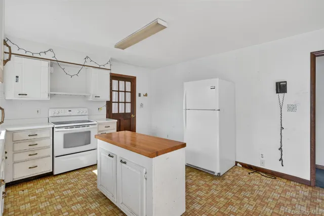 wooden floor chandelier and windows in a room